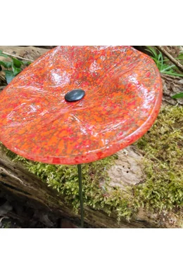 Transparent basic color oval glass flower with orange-red dots, for outdoor use, on a 43 cm steel stem