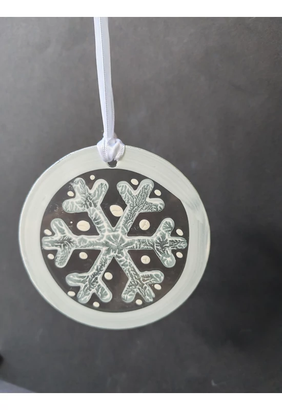 White hand-painted snowflake-shaped glass ornament