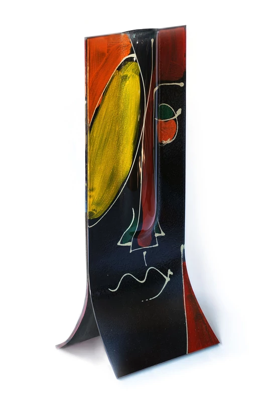 Glass vase made using the burn-in technique in a black and yellow color scheme reminiscent of a cubist face, 14x36 cm